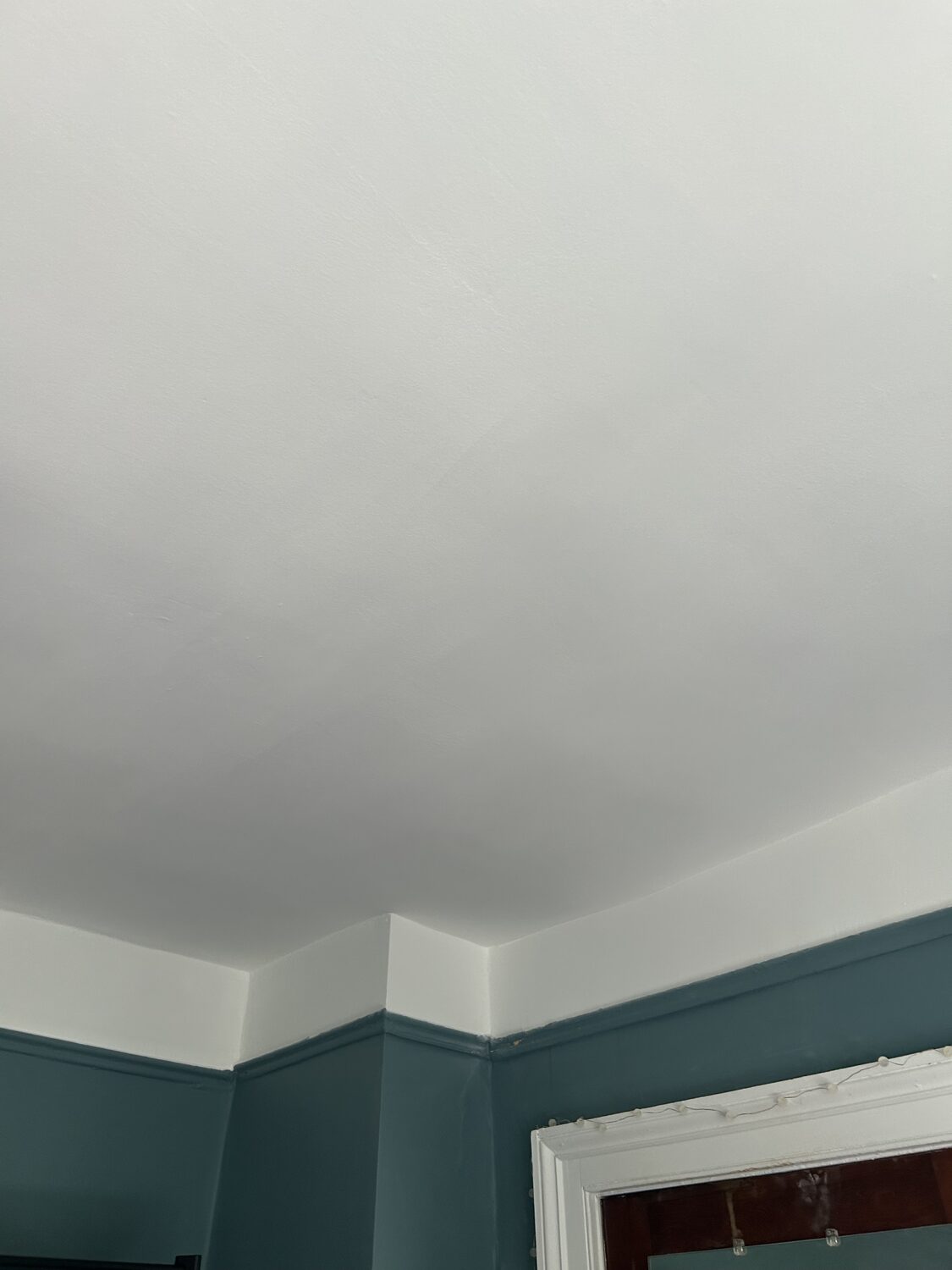 Ceiling repaired and repainted in teal room