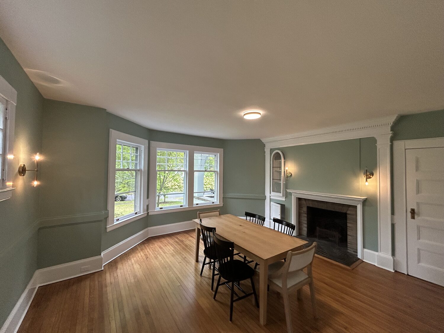 Same dining room repainted soft sage green