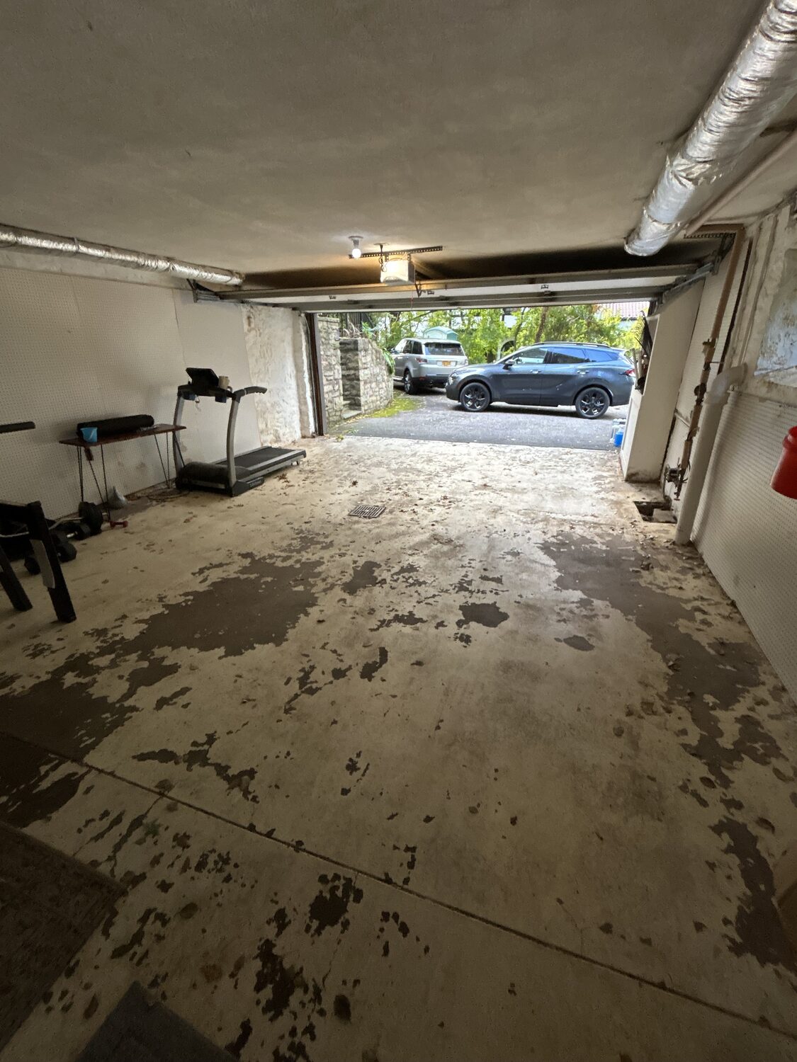 Garage with peeling floor before refinishing