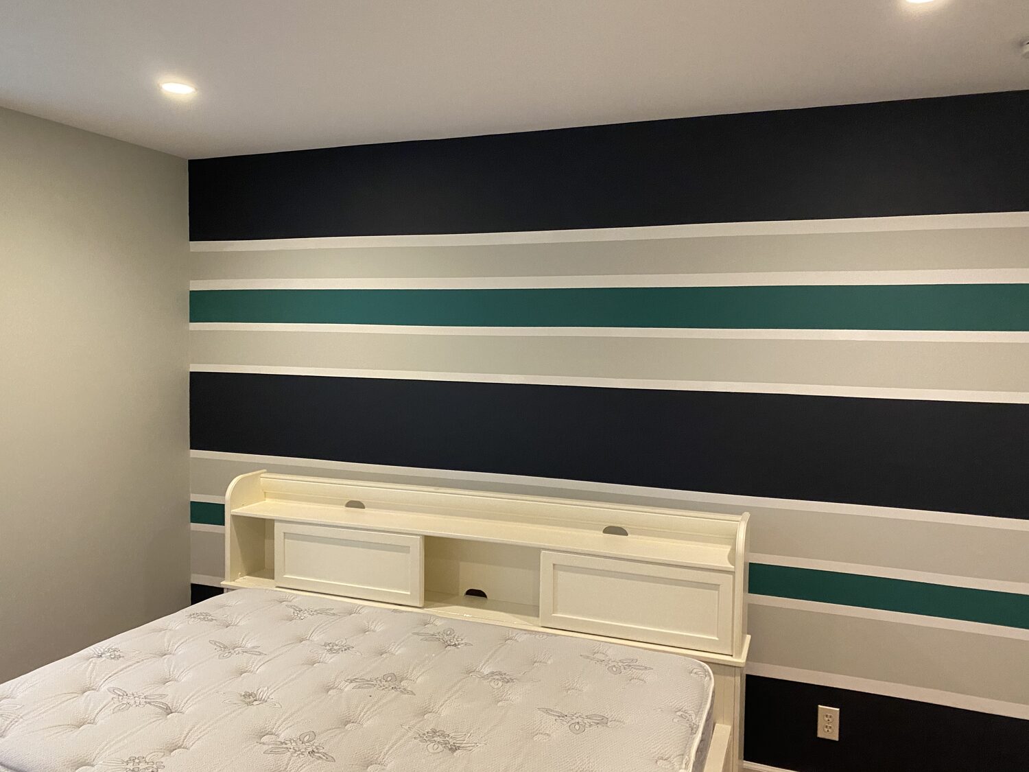 Finished custom striped accent wall in navy and teal