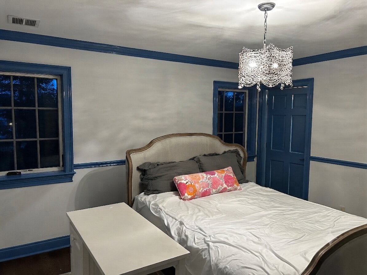 Bedroom repainted gray with navy doors and trim