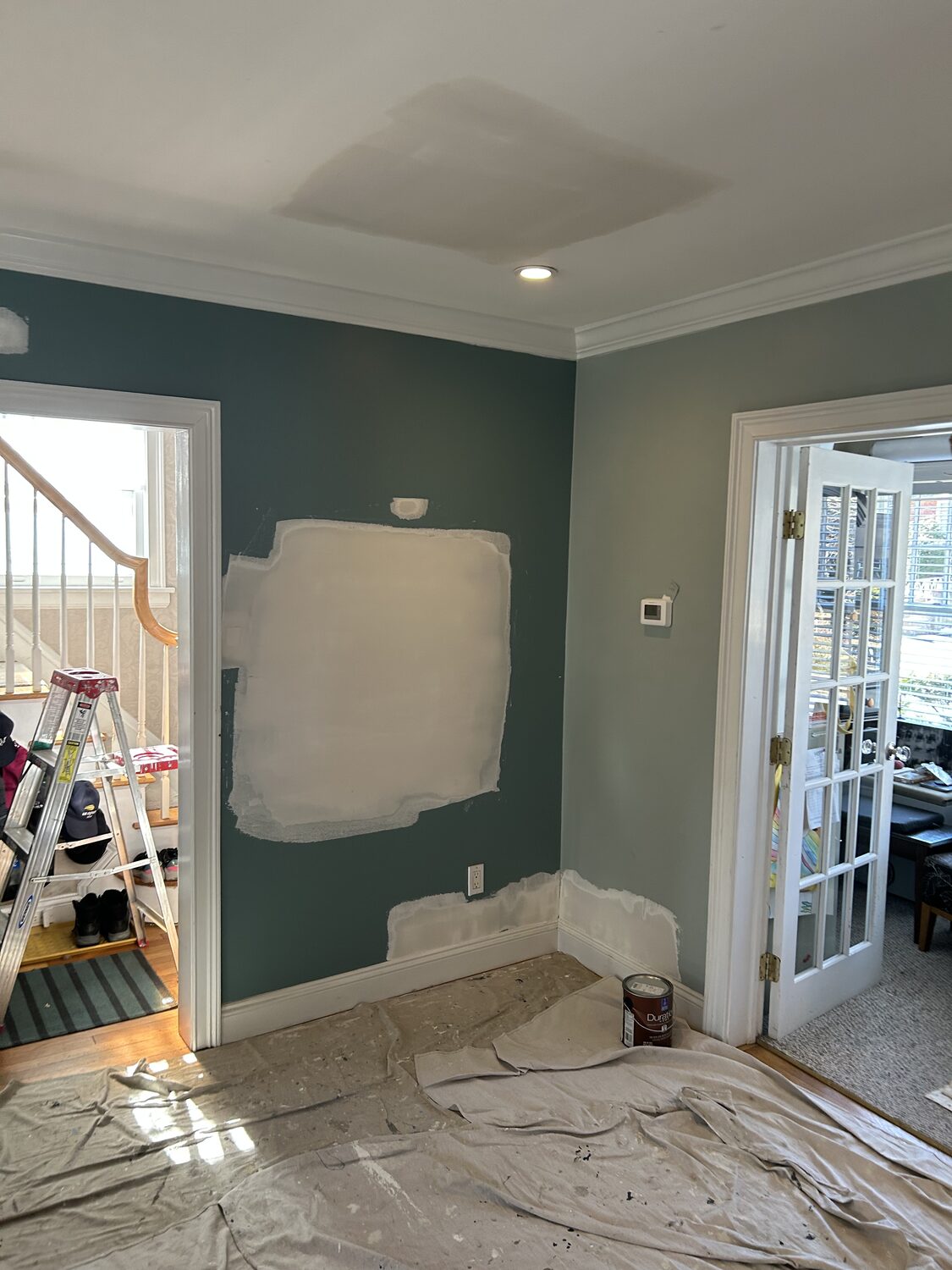 Teal wall with large patch repair before painting